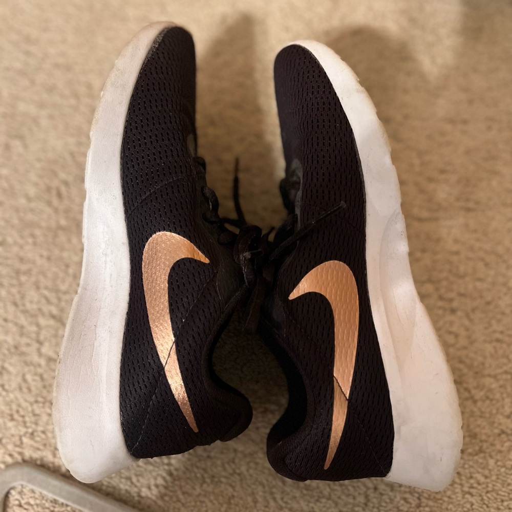 Dark purple Nikes. Rose gold Nike symbol. Size 8. Worn very little.